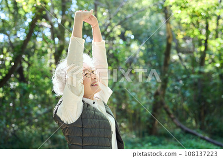 A woman enjoying forest bathing 108137223