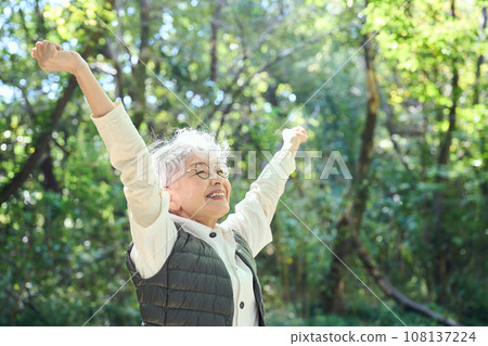 A woman enjoying forest bathing A woman enjoying forest bathing 108137224