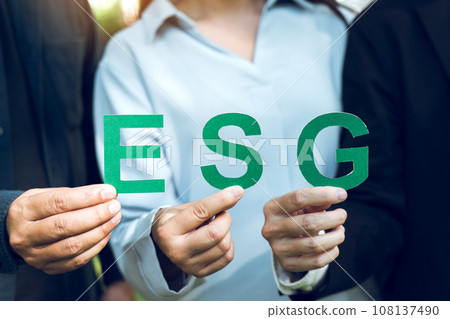 Hands of business team holding ESG text, Environmental, social and corporate governance concept. Hands of business team holding ESG text, Environmental, social and corporate governance concept. 108137490
