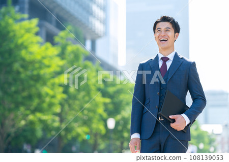 Middle-aged businessman working in an office district Middle-aged businessman working in an office district 108139053