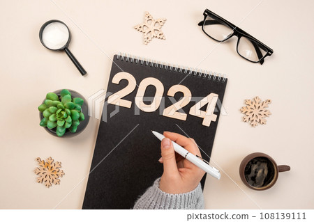New Year Aims 2024. To Do List. Empty Notebook at the Desk with Holiday Decoration. Top view. Creating Plan, Resolution. New Life, Start Up, Beginning Concept. Business ideas. Goals, action, checklist 108139111