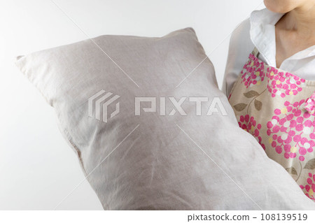 A housewife concerned about the smell of her pillow A housewife concerned about the smell of her pillow 108139519