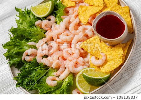 shrimps with lettuce, corn chips, chili sauce shrimps with lettuce, corn chips, chili sauce 108139837