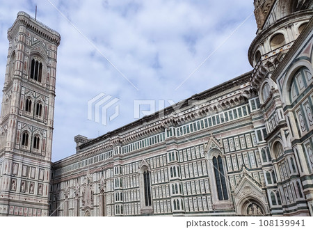 Details of the exterior of the di Santa Maria del Fiore or Cathedral of Saint Mary of the Flower - the main church of Florence, Tuscany, Italy. 108139941