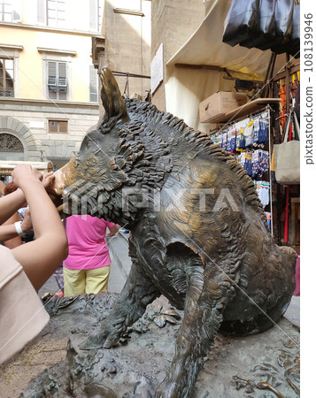 Detail of Hand touching good luck copper pig statue in Florence Detail of Hand touching good luck copper pig statue in Florence 108139946