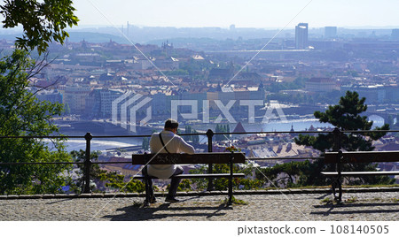 The capital of the Czech Republic is Prague. Beautiful panorama of the city. Panoramic view of Prague in a blue haze. Bench in a beautiful place from where you can see the city The capital of the Czech Republic is Prague. Beautiful panorama of the city. Panoramic view of Prague in a blue haze. Bench in a beautiful place from where you can see the city 108140505