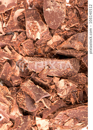 pieces of chocolate and crumbs for cooking and making fondue on a white background pieces of chocolate and crumbs for cooking and making fondue on a white background 108140512