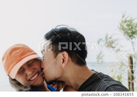 Selfie portrait of lovely and cheerful couple hug and kiss. Selfie portrait of lovely and cheerful couple hug and kiss. 108141655