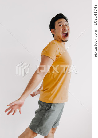 Vertical half body of funny wow face man jumping isolated on white. 108141748