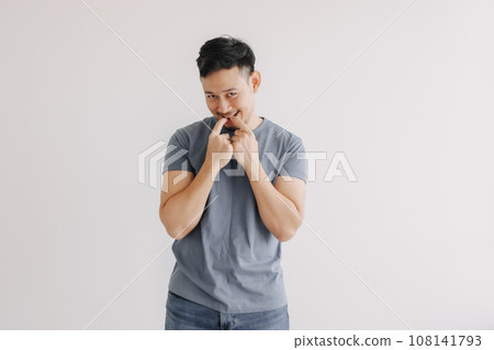 Shy and embarrassment funny man in blue t-shirt isolated on white wall.  108141793