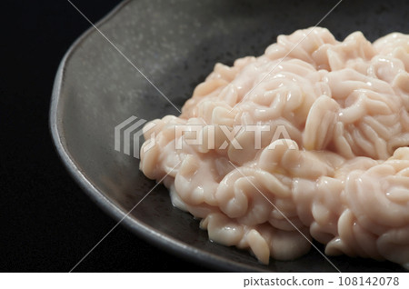 Raw pollack milt on a black plate Raw pollack milt on a black plate 108142078