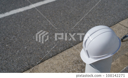 Asphalt-paved road and helmet - Image of construction industry, paving work, etc. Asphalt-paved road and helmet - Image of construction industry, paving work, etc. 108142271