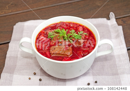Borscht soup with vegetables and meat on a wooden table 108142448