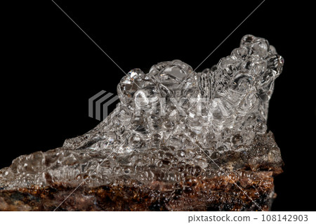 Macro Hyalite mineral stone on a black background Macro Hyalite mineral stone on a black background 108142903