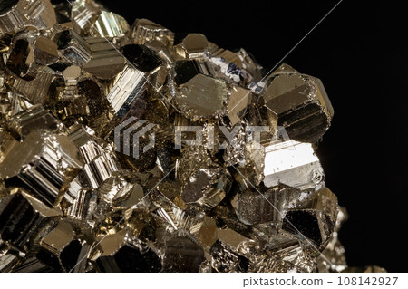 Macro mineral pyrite stone black background Macro mineral pyrite stone black background 108142927