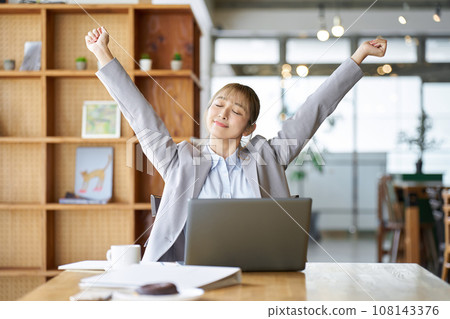 Asian woman stretching while working Asian woman stretching while working 108143376
