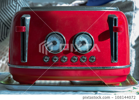 Red retro styled toaster for breakfast. Toaster in vintage style. 108144072