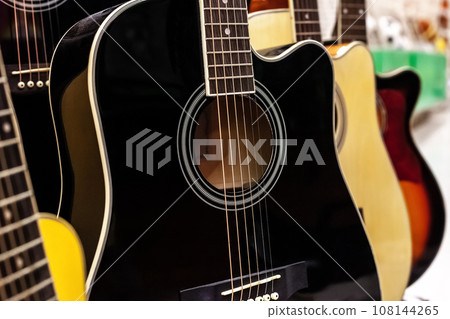 Guitars rows sale in music store Guitars rows sale in music store 108144265