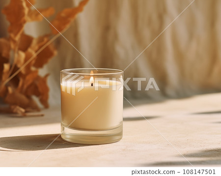 Minimalist burning wax candle in clear glass on natural beige stone background with copy space, styled commercial product mockup Minimalist burning wax candle in clear glass on natural beige stone background with copy space, styled commercial product mockup 108147501