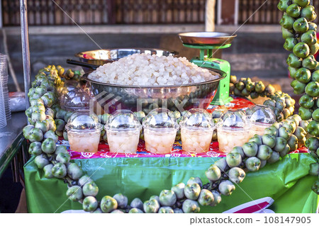 Seeds of sugar palm sold at Phuket night market, Thailand. Translucent Kolang kaling in large metal bowl selling on street Seeds of sugar palm sold at Phuket night market, Thailand. Translucent Kolang kaling in large metal bowl selling on street 108147905