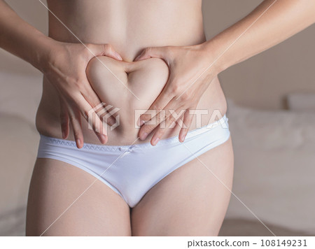 woman loves her body and excess weight. fat with love. hands on the stomach 108149231