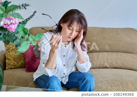 Middle-aged woman experiencing stress, difficulties, headache Middle-aged woman experiencing stress, difficulties, headache 108149368