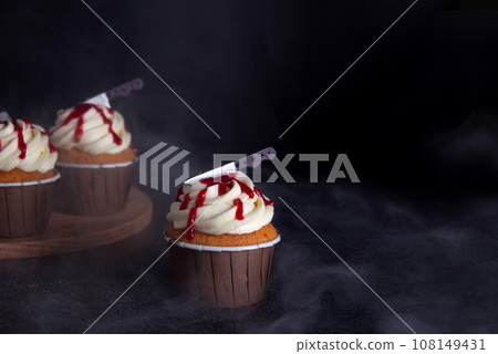 Close up photo of scary, bloody Halloween cupcakes. Black background. Food photo Close up photo of scary, bloody Halloween cupcakes. Black background. Food photo 108149431