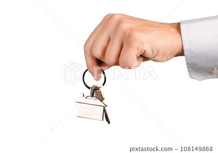 Man holding house keys with house shaped keychain 108149868