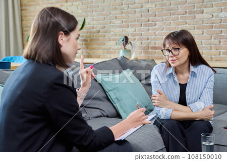Middle aged woman on therapy session in psychologist's office Middle aged woman on therapy session in psychologist's office 108150010