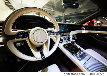 Car interior luxury. Interior of prestige modern car. Dashboard and steering wheel. Car interior luxury. Interior of prestige modern car. Dashboard and steering wheel. 108150724