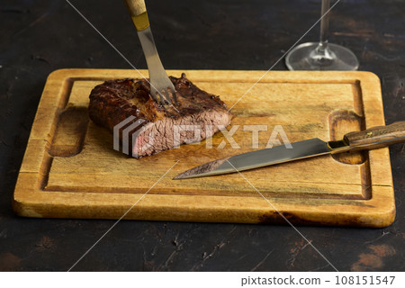 Roasted beef ribs presented on the table, traditional Argentine cuisine, Asado barbecue, Patagonia, Argentina. Roasted beef ribs presented on the table, traditional Argentine cuisine, Asado barbecue, Patagonia, Argentina. 108151547