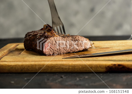 Roasted beef ribs presented on the table, traditional Argentine cuisine, Asado barbecue, Patagonia, Argentina. Roasted beef ribs presented on the table, traditional Argentine cuisine, Asado barbecue, Patagonia, Argentina. 108151548