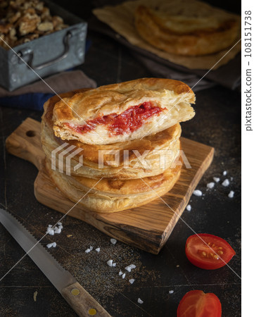 Rustico puff pastry from Lecce filled with stuffed with tomato, mozzarella and bechamel sauce Rustico puff pastry from Lecce filled with stuffed with tomato, mozzarella and bechamel sauce 108151738