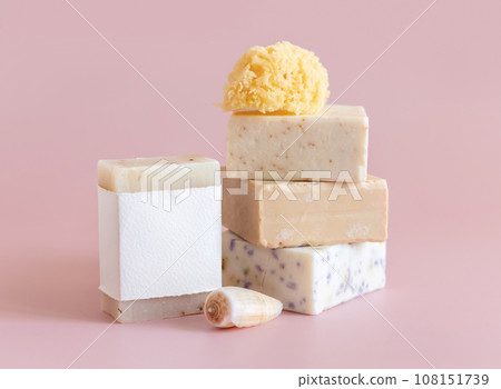Soap bars with blank label, natural sponge and seashell on pink close up, mockup 108151739