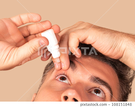Young man uses eye drops for eye treatment. Redness, Dry Eyes, Allergy and Eye Itching Young man uses eye drops for eye treatment. Redness, Dry Eyes, Allergy and Eye Itching 108151848