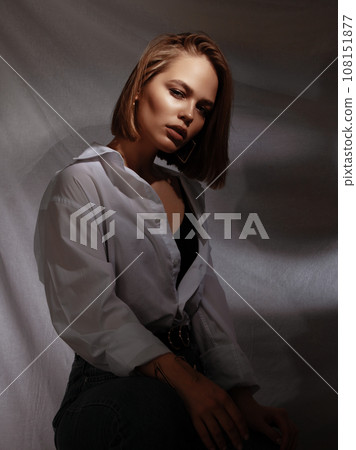 A lovely model with gold rings, earrings, and a A lovely model with gold rings, earrings, and a 108151877