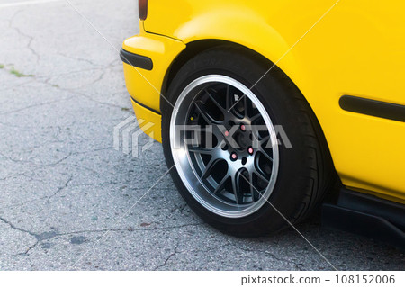 Lowrider custom stance stylish sports car closeup. Yellow car 108152006