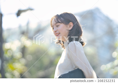 Young woman walking outdoors in suit 108152231