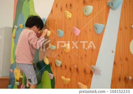 child enjoying bouldering 108152233
