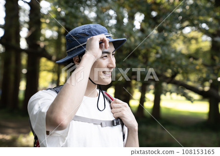 A man walking with a mountain climbing bag A man walking with a mountain climbing bag 108153165