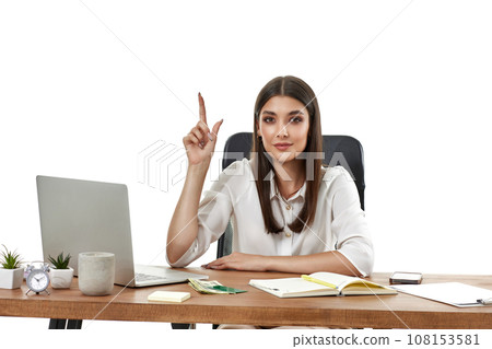 woman using laptop and pointing at copy space woman using laptop and pointing at copy space 108153581