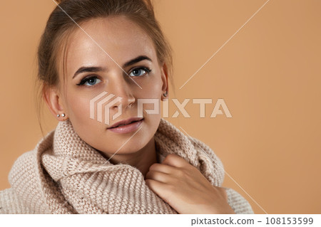 young pretty woman wearing knitted sweater and scarf young pretty woman wearing knitted sweater and scarf 108153599