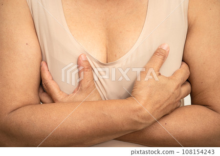 Asian woman patient checking and worry her breast, Breast Self Exam or BES, symbol of World Breast Cancer Day. 108154243