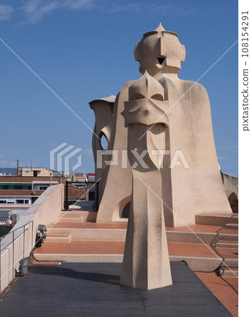 Artistic chimneys on rooftop in city of Barcelona in Spain - vertical Artistic chimneys on rooftop in city of Barcelona in Spain - vertical 108154291