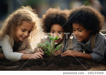 Beautiful little multi-ethnic children bend over a tiny green sprout in the garden. Adorable enfants with different skin colors plant a plant in the ground together. Diversity and free communication. 108155049
