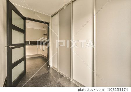 an empty room with white walls and black trim on the doors, there is no one person in the room 108155174