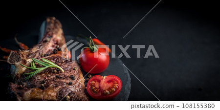 Grilled beef steak on bone with tomatoes Grilled beef steak on bone with tomatoes 108155380