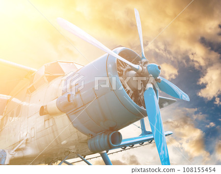 plane with propeller on sunset sky background plane with propeller on sunset sky background 108155454