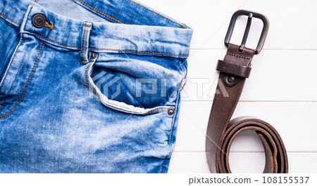 male jeans and belt on wooden background 108155537
