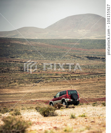off-road car against mountains 108155927